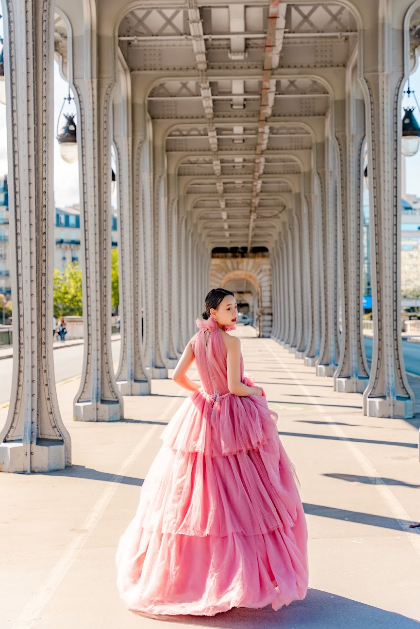 Elegant couple walking near the Eiffel Tower during sunrise photoshoot